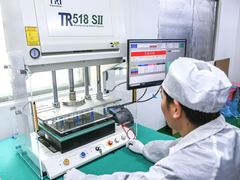 PCBA Assembly Defect Verification and Electrical Testing Operator performing PCBA electrical defect testing at a production test station