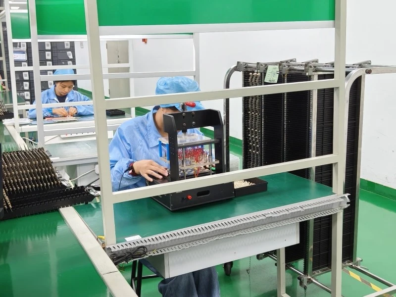 PCBA Production Test Fixture and Measurement Setup Operator using a production test fixture for PCBA functional verification