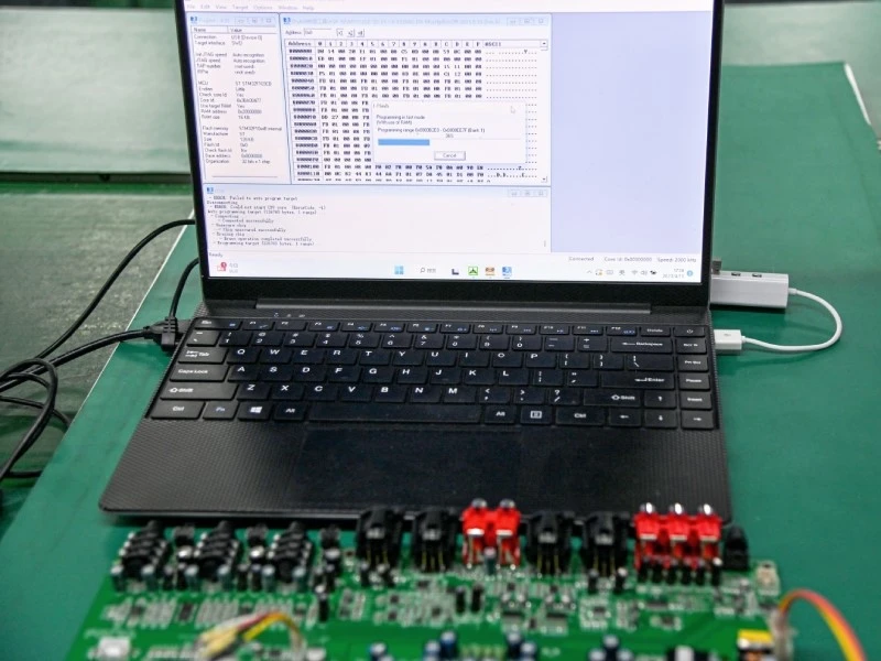 PCBA Firmware Programming and Configuration Control PCBA connected to a laptop for firmware programming and configuration