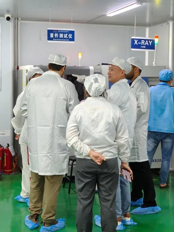 Two visitors from Saudi Arabia reviewing the first article inspection system before further SMT production at STHL