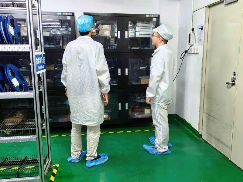 Visitor from Pakistan reviewing electronic component storage and material readiness at STHL