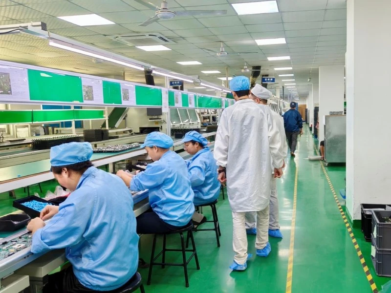 Visitor reviewing the THT/DIP assembly area at STHL's PCB assembly factory