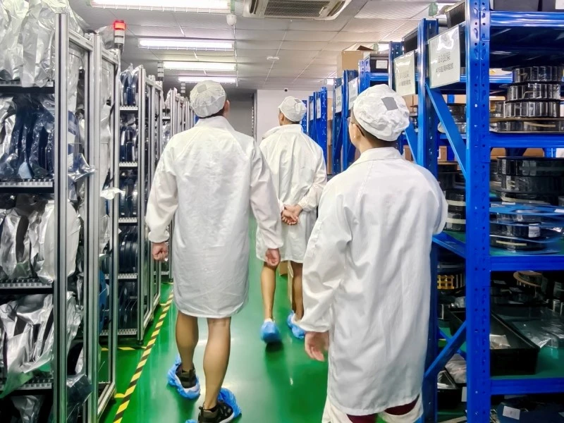 Visitors from Japan walking through STHL's PCBA manufacturing facility during the factory tour