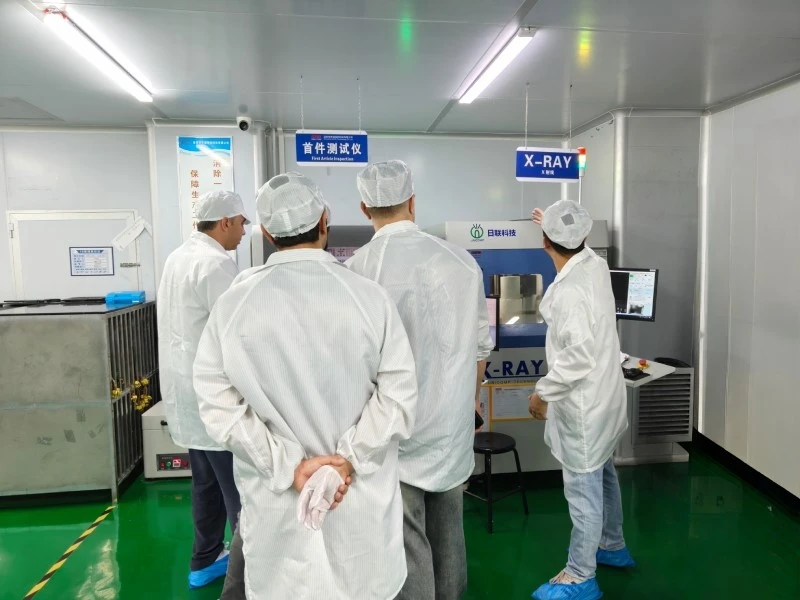 STHL Factory Visit - First-Article Inspection and X-ray Component Counting Italian visitors viewing first-article inspection equipment and an X-ray component counter at STHL
